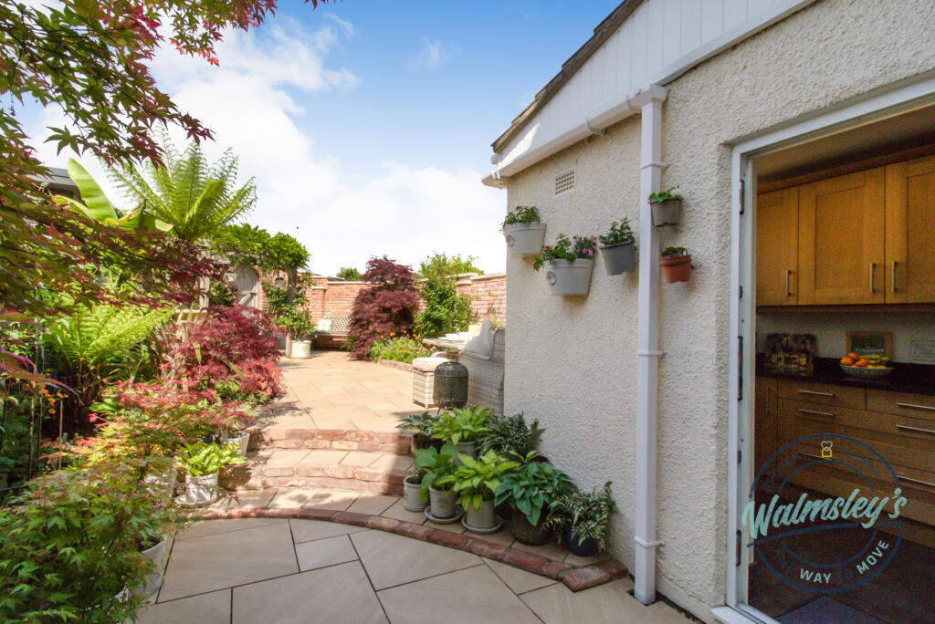 Landscaped gardens and access into kitchen