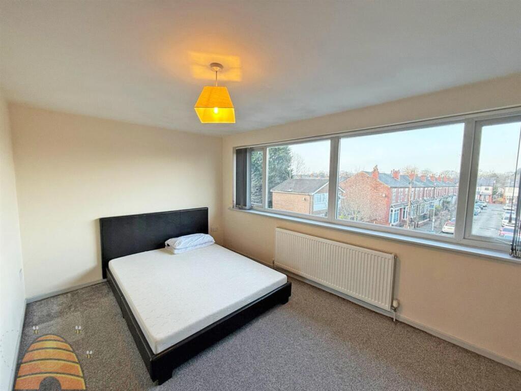 A bright and spacious double bedroom featuring ...