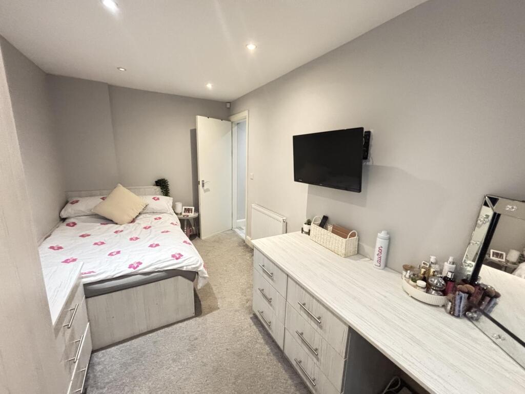 A well-maintained bedroom featuring a comfortab...