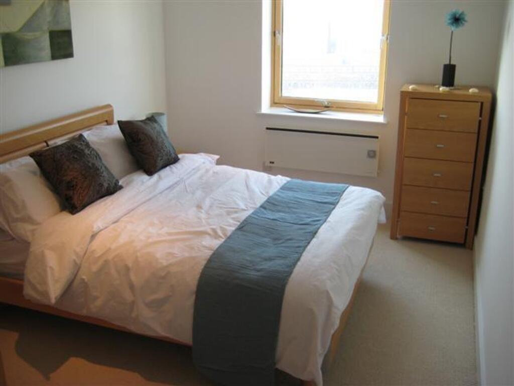 Bright and cozy double bedroom featuring a comf...