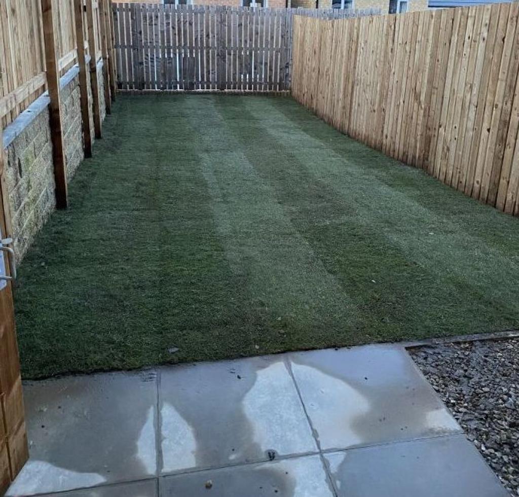 Newly lawned garden with gravelled and flagged are