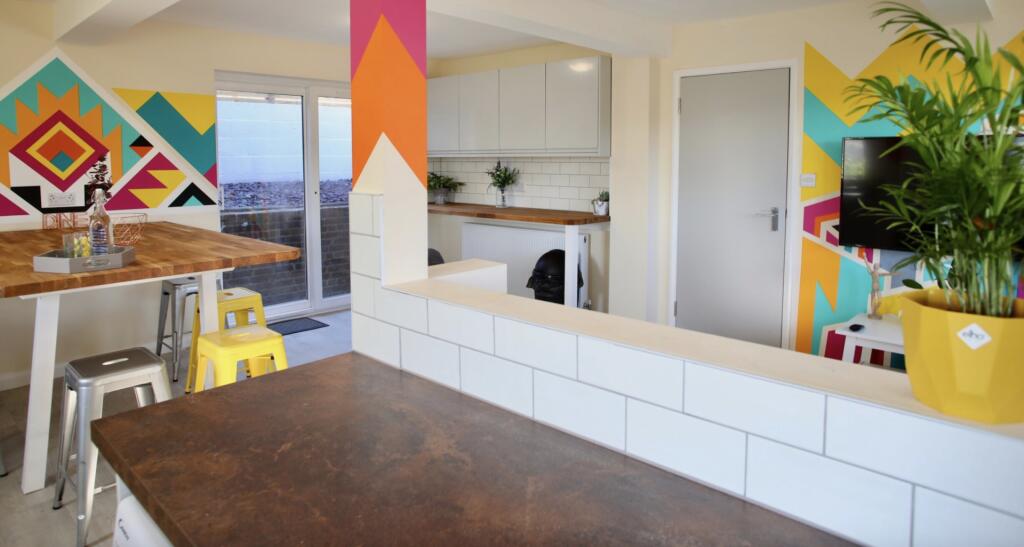 Bright and vibrant kitchen space featuring mode...