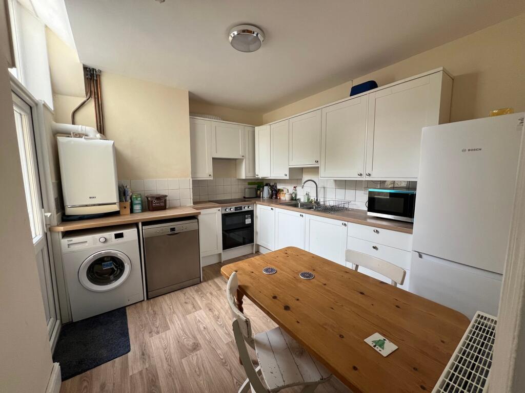 A bright and tidy kitchen featuring modern appl...