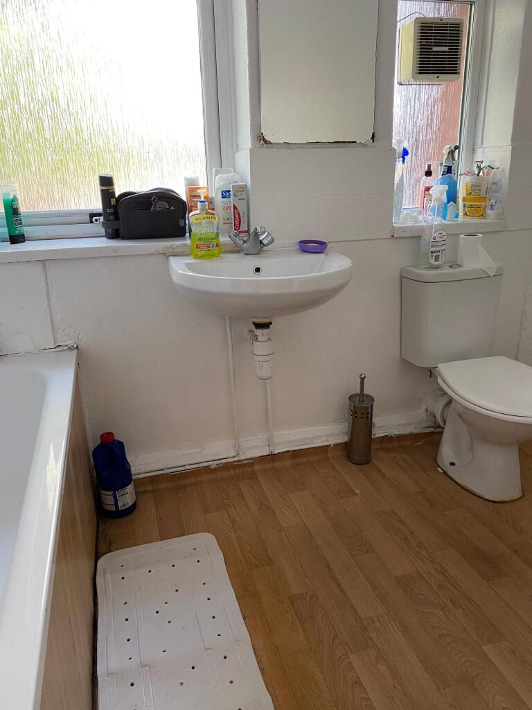 Bright and functional bathroom featuring a spac...