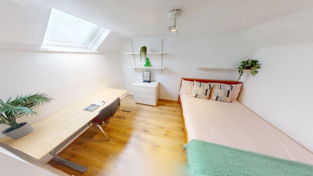 A bright and inviting double bedroom featuring ...