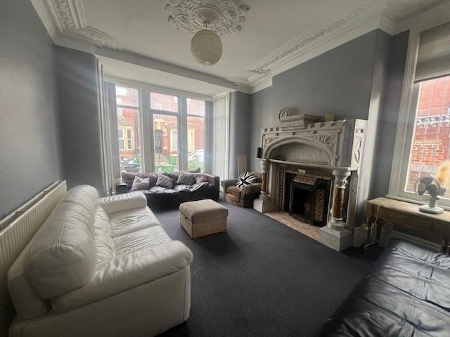 Elegant, high-ceilinged living room with decora...