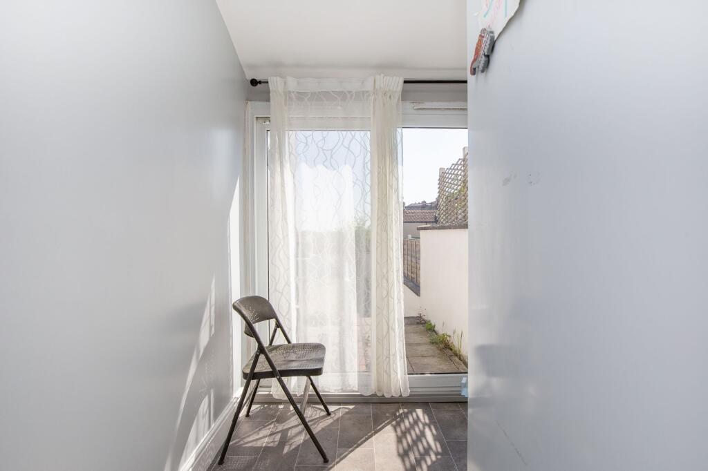 A bright and clean hallway featuring large glas...