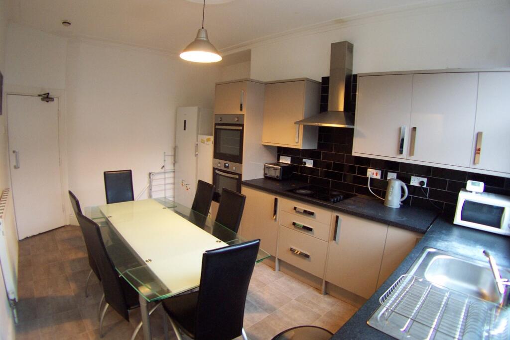 A modern, well-maintained kitchen with ample wo...