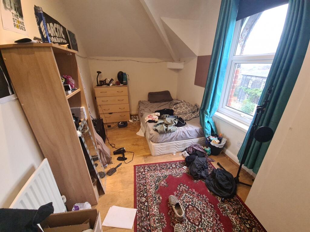 Cozy single bedroom featuring a comfortable bed...