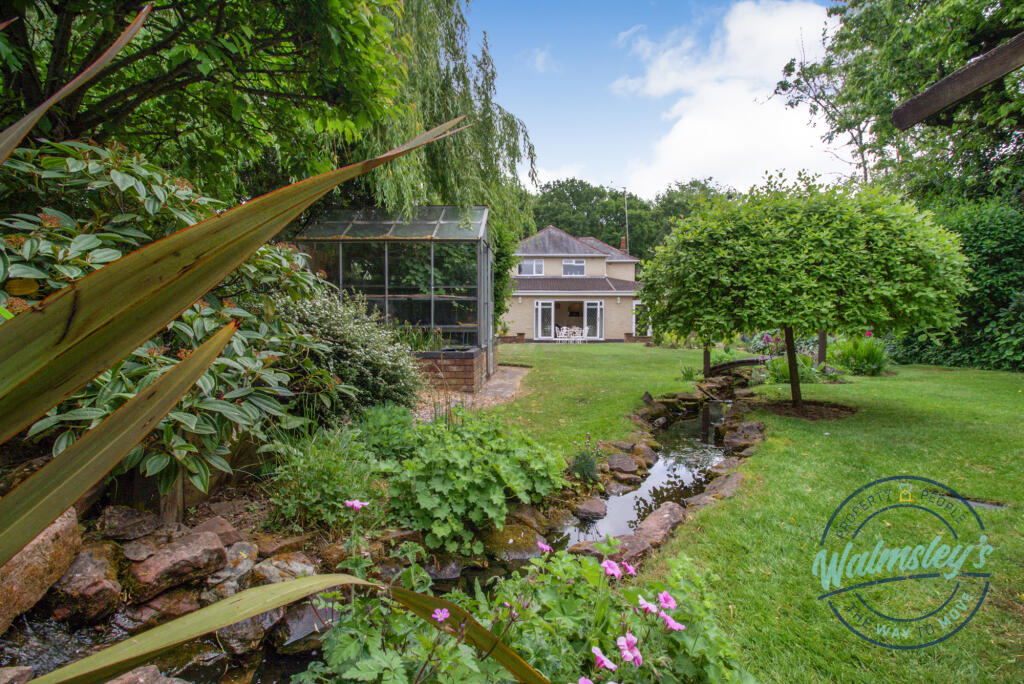 Rear elevation, greenhouse and stream