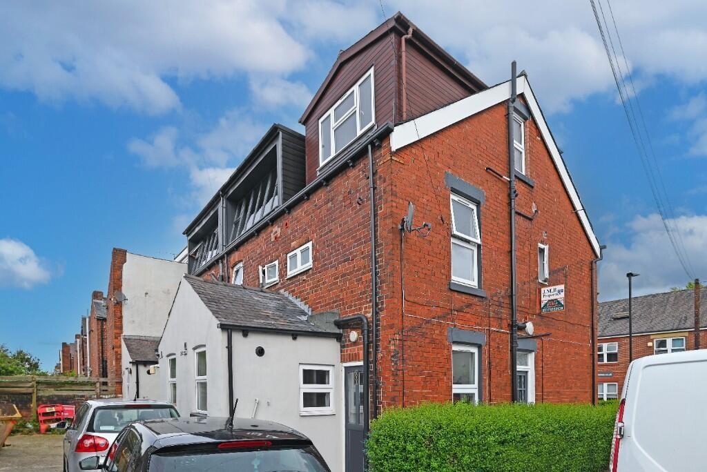 A well-maintained red brick semi-detached house...