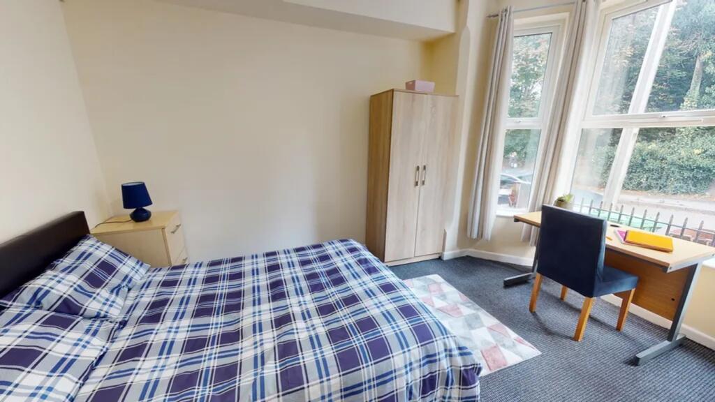 A bright and inviting double bedroom with ample...