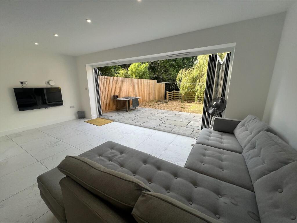A modern living room featuring a plush grey sec...