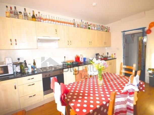 Bright and welcoming kitchen featuring light wo...