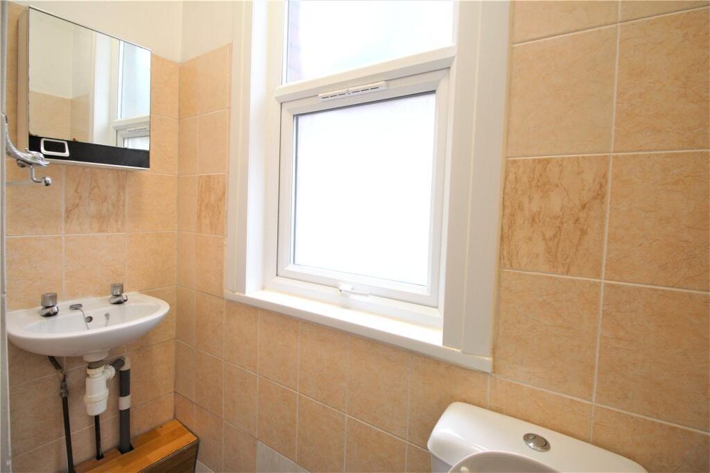 A neat and well-maintained bathroom with beige ...