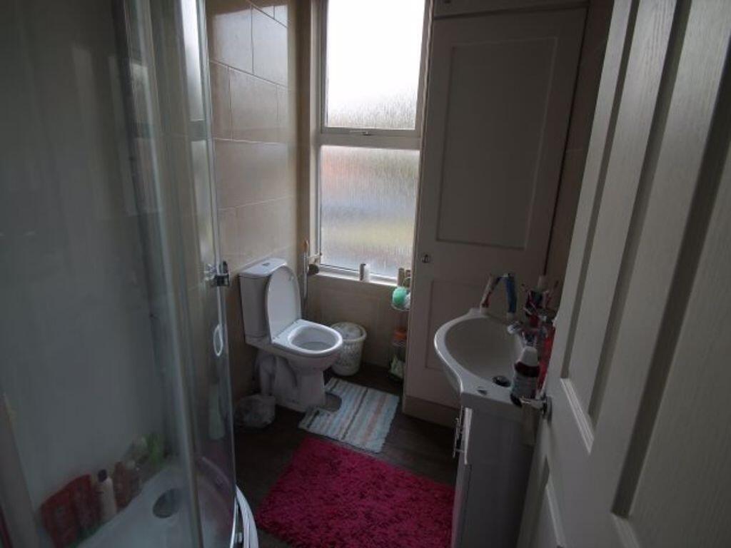 A clean and functional bathroom featuring a sho...