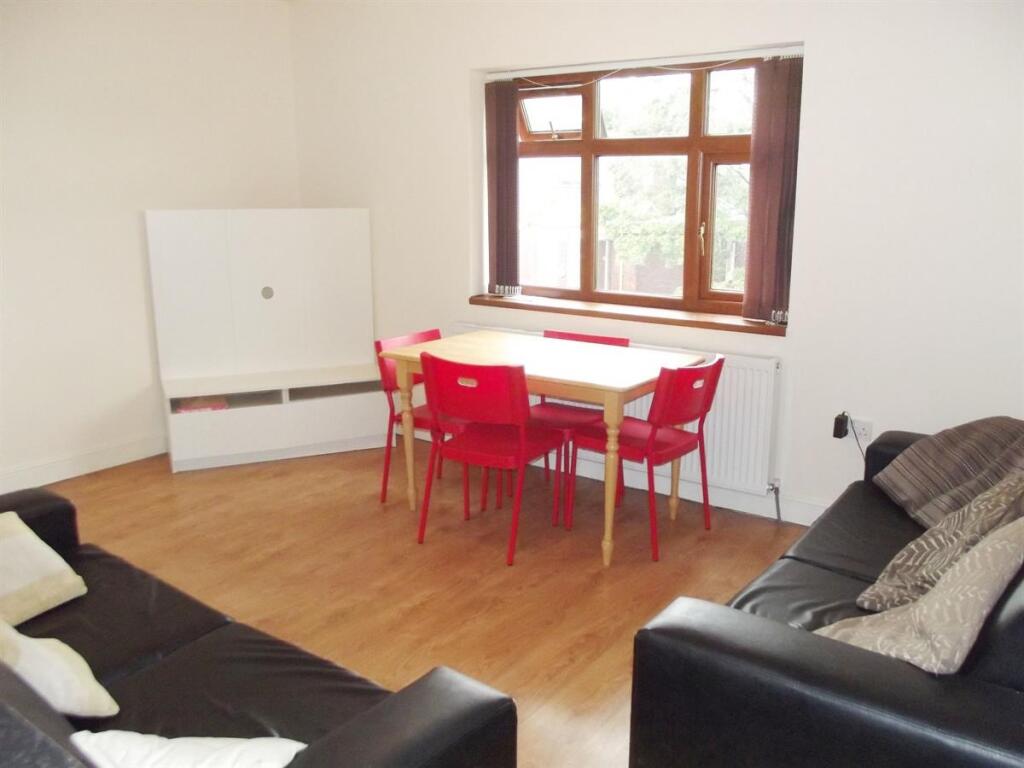 A bright and spacious living room with large wi...