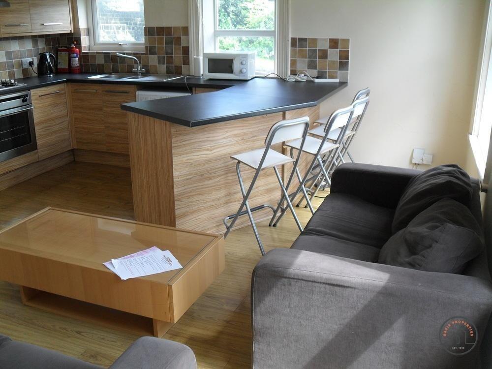 A modern, well-lit living room featuring comfor...