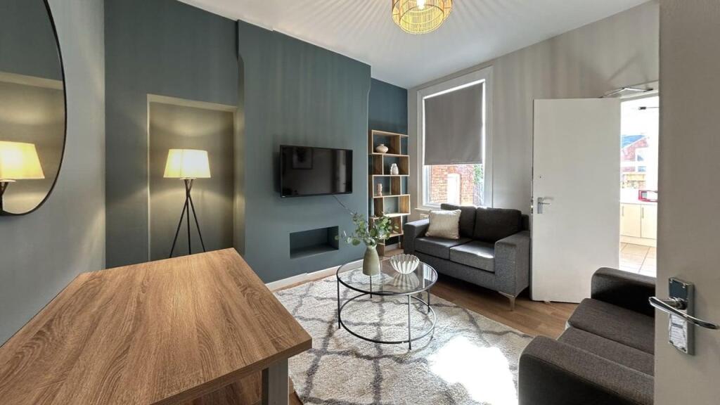 A bright and modern living room featuring a com...