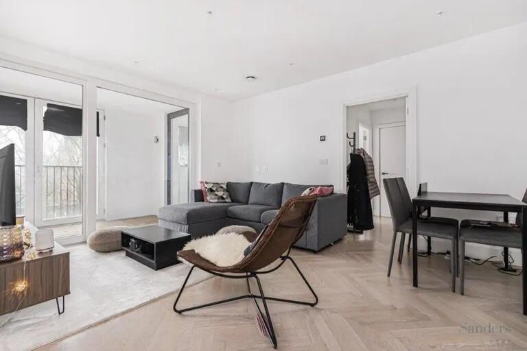 A contemporary living room featuring a spacious...