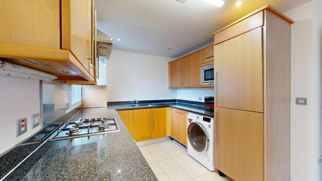 Modern kitchen with wooden cabinets, a stainles...