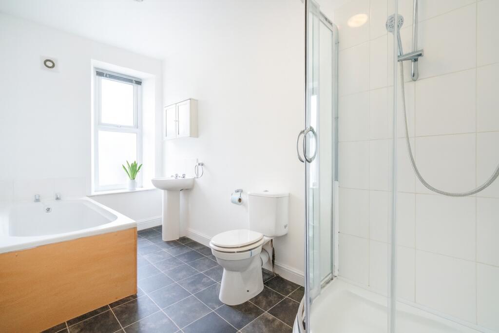 Bright and modern bathroom featuring a large ba...