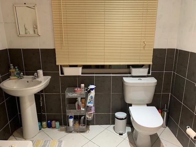 A well-maintained bathroom featuring a bathtub,...