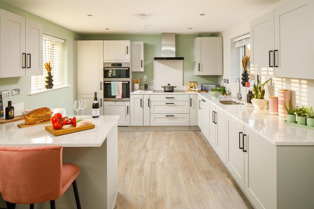 The modern kitchen has ample storage space and a stylish breakfast bar