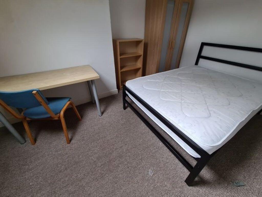 A simple and clean single bedroom featuring a s...