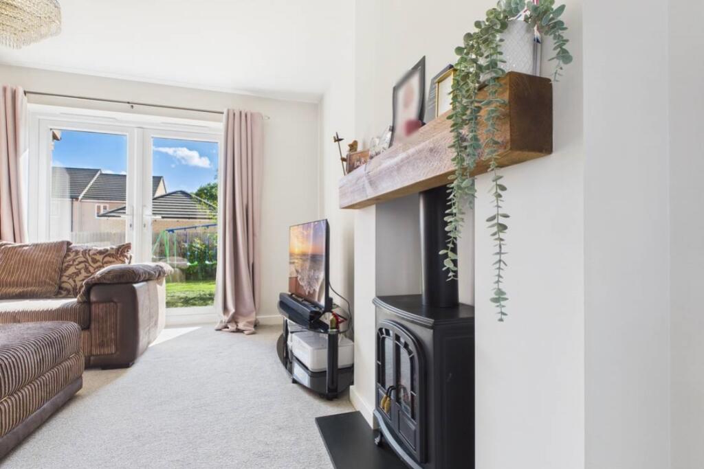 A cosy electric fireplace in the lounge adding cha