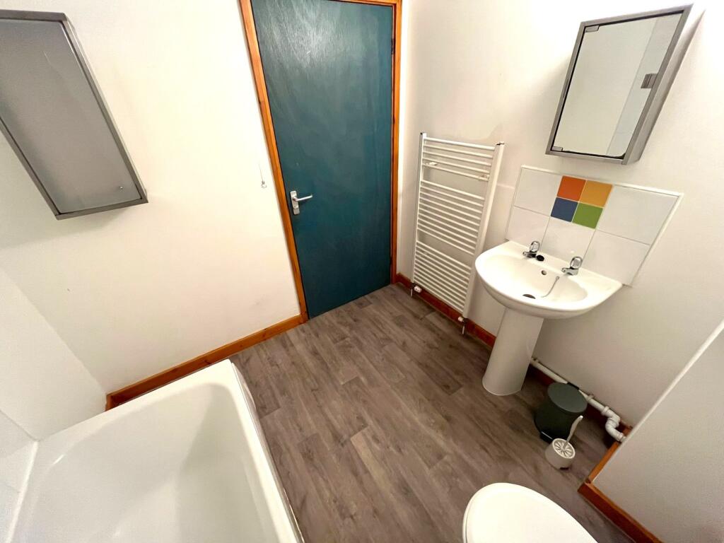 A bright and tidy bathroom featuring modern fix...