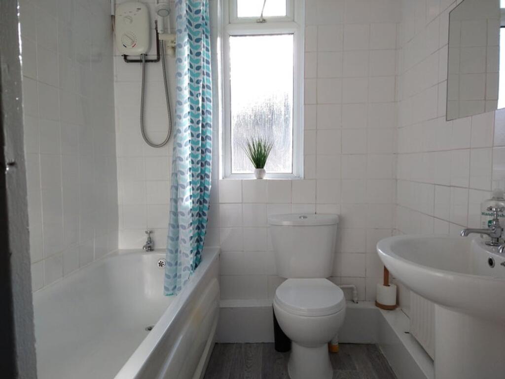 A bright and well-maintained bathroom featuring...