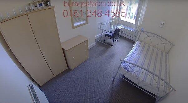Bright, simply furnished bedroom with a metal-f...