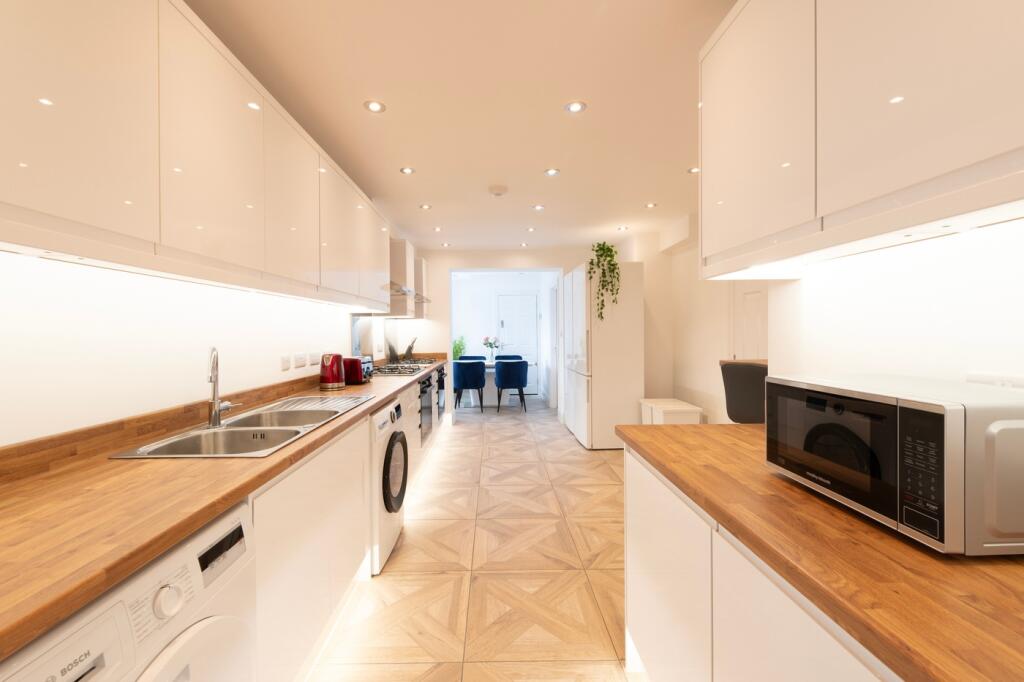 A modern and spacious kitchen with ample natura...