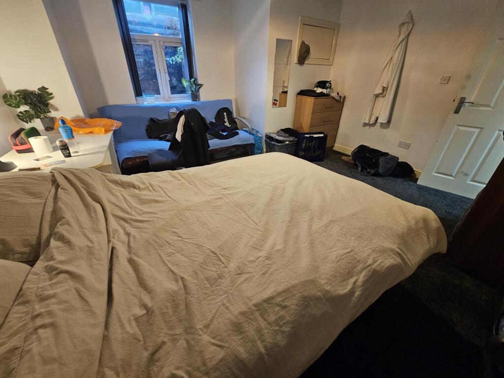 A well-maintained double bedroom featuring a la...