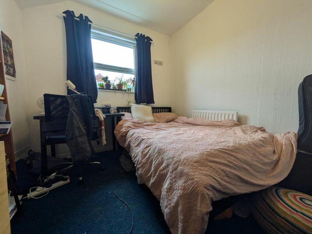 A cozy double bedroom with a comfortable bed an...