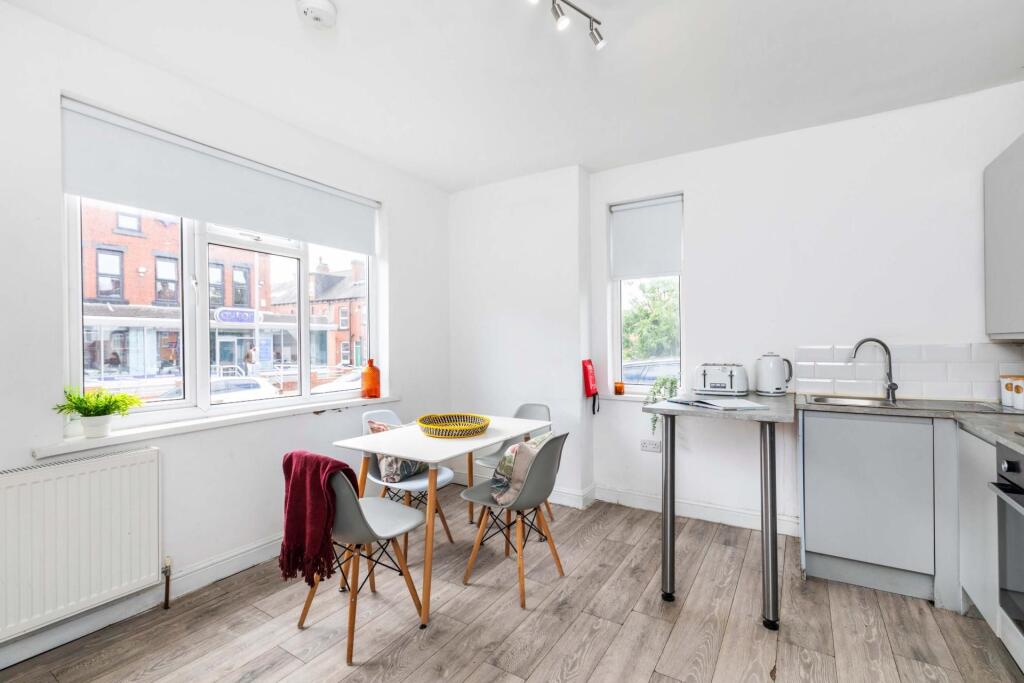 Bright and modern kitchen area with ample natur...