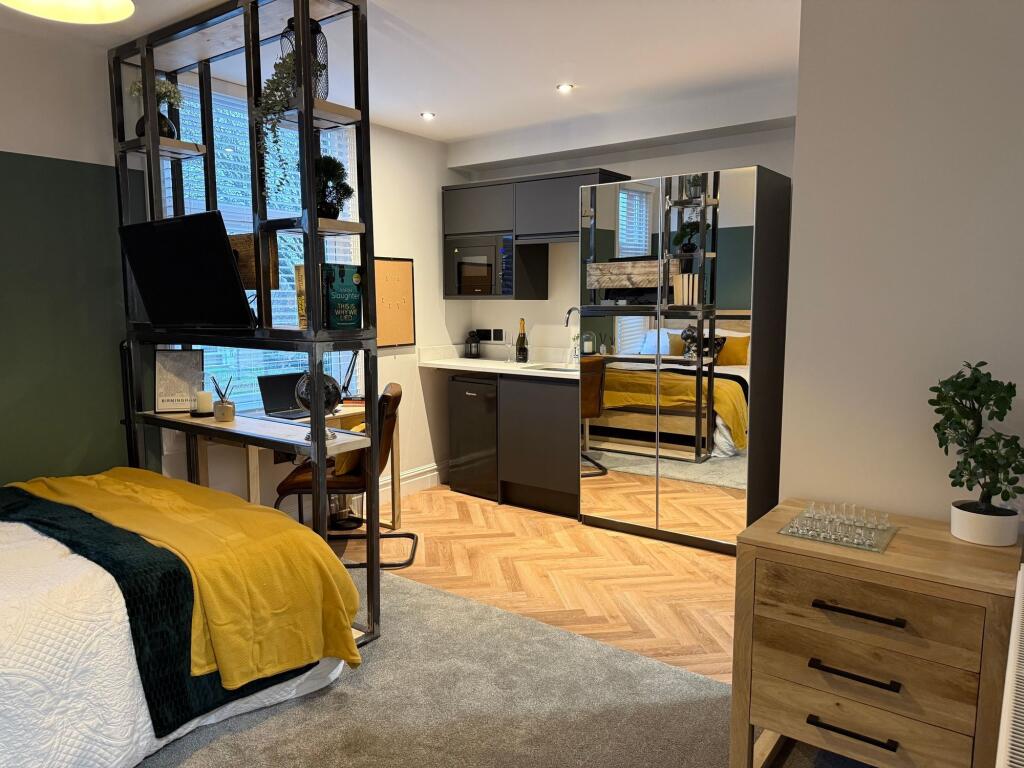 A stylish master bedroom featuring a cozy doubl...
