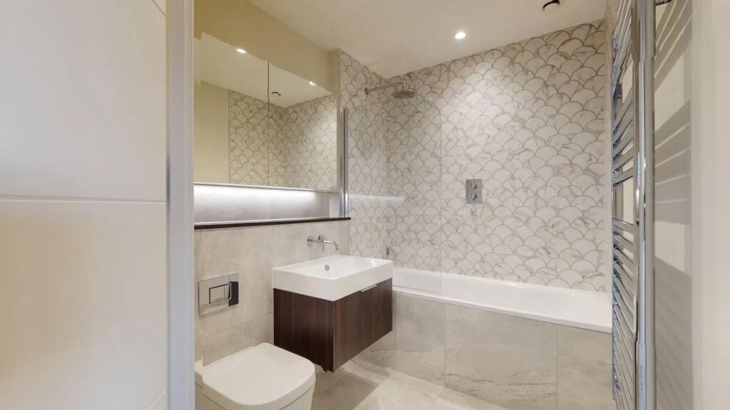 A modern and stylish bathroom suite featuring e...