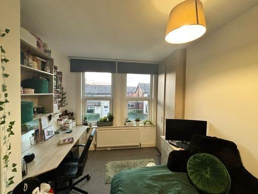 A bright and welcoming living room with a large...