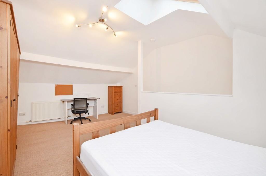 Bright and spacious master bedroom featuring a ...
