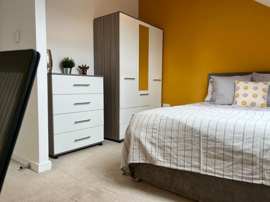 A bright and inviting double bedroom featuring ...