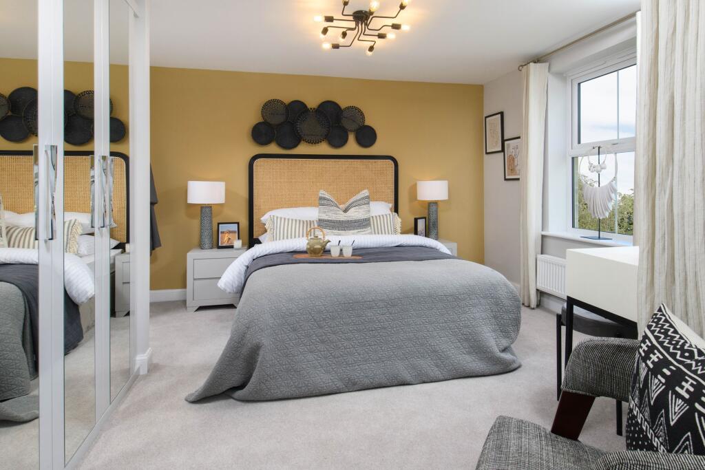 Main bedroom with built-in storage in Millford style home