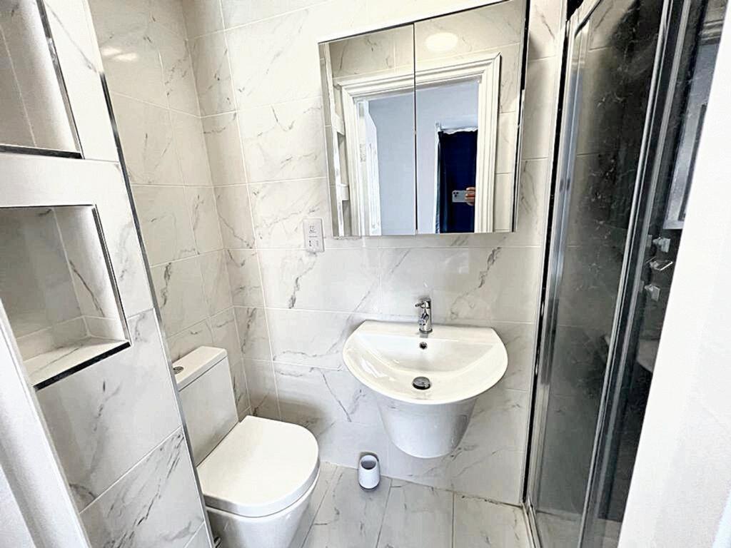 A modern bathroom suite featuring elegant marbl...