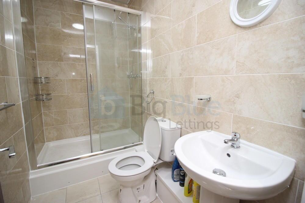 A bright and modern bathroom suite featuring a ...