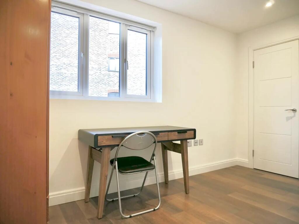 A bright and neat communal workspace featuring ...