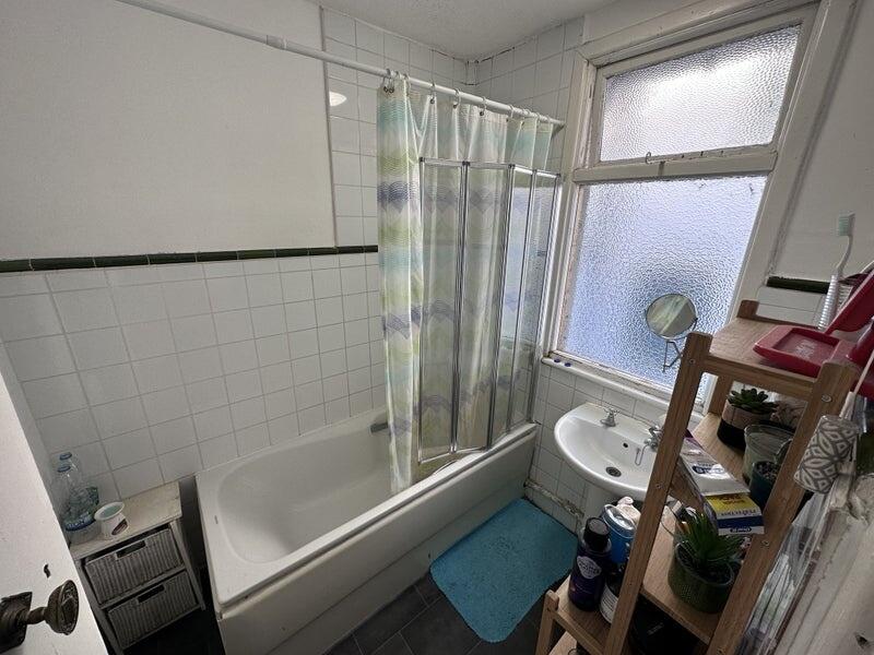 A clean and functional bathroom suite featuring...