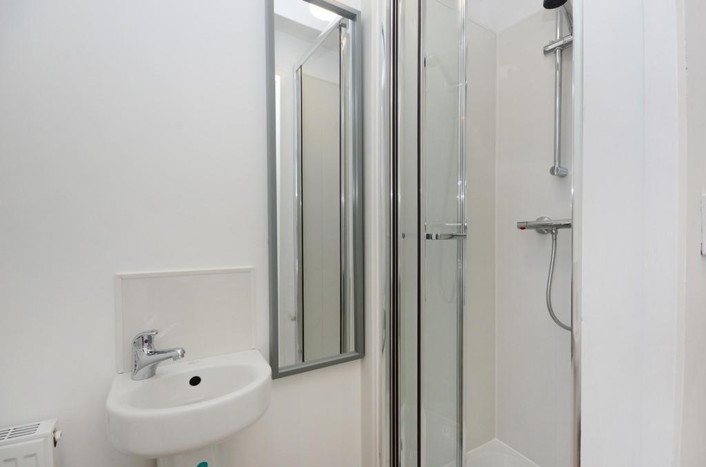 A clean and modern bathroom featuring a compact...