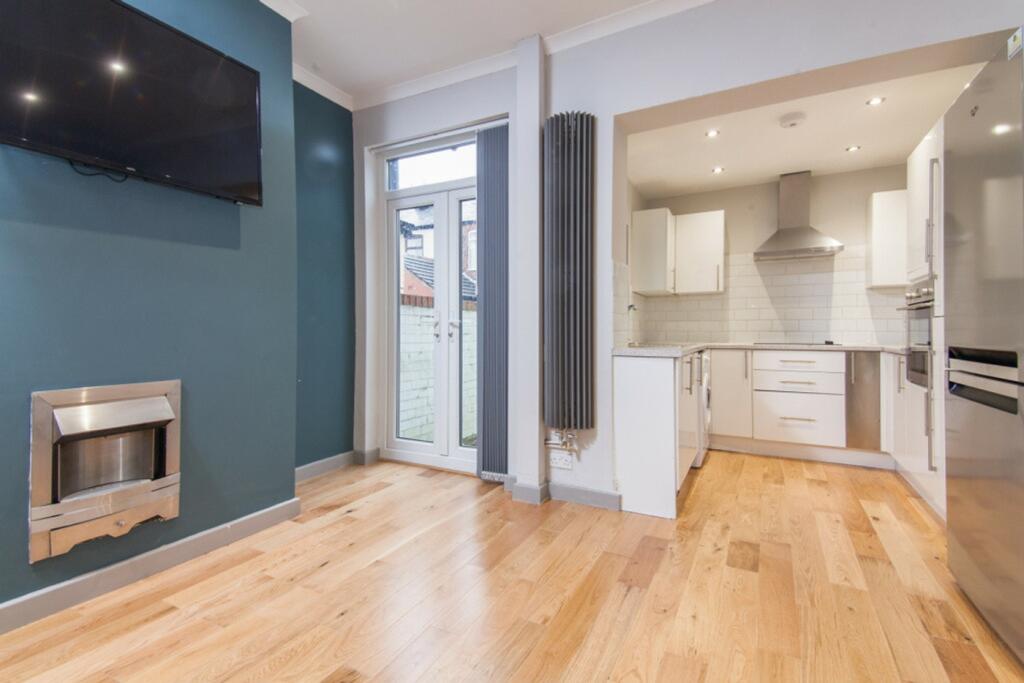 A bright and modern kitchenette with sleek fini...