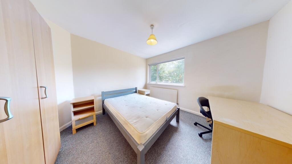 Bright and tidy double bedroom featuring a larg...